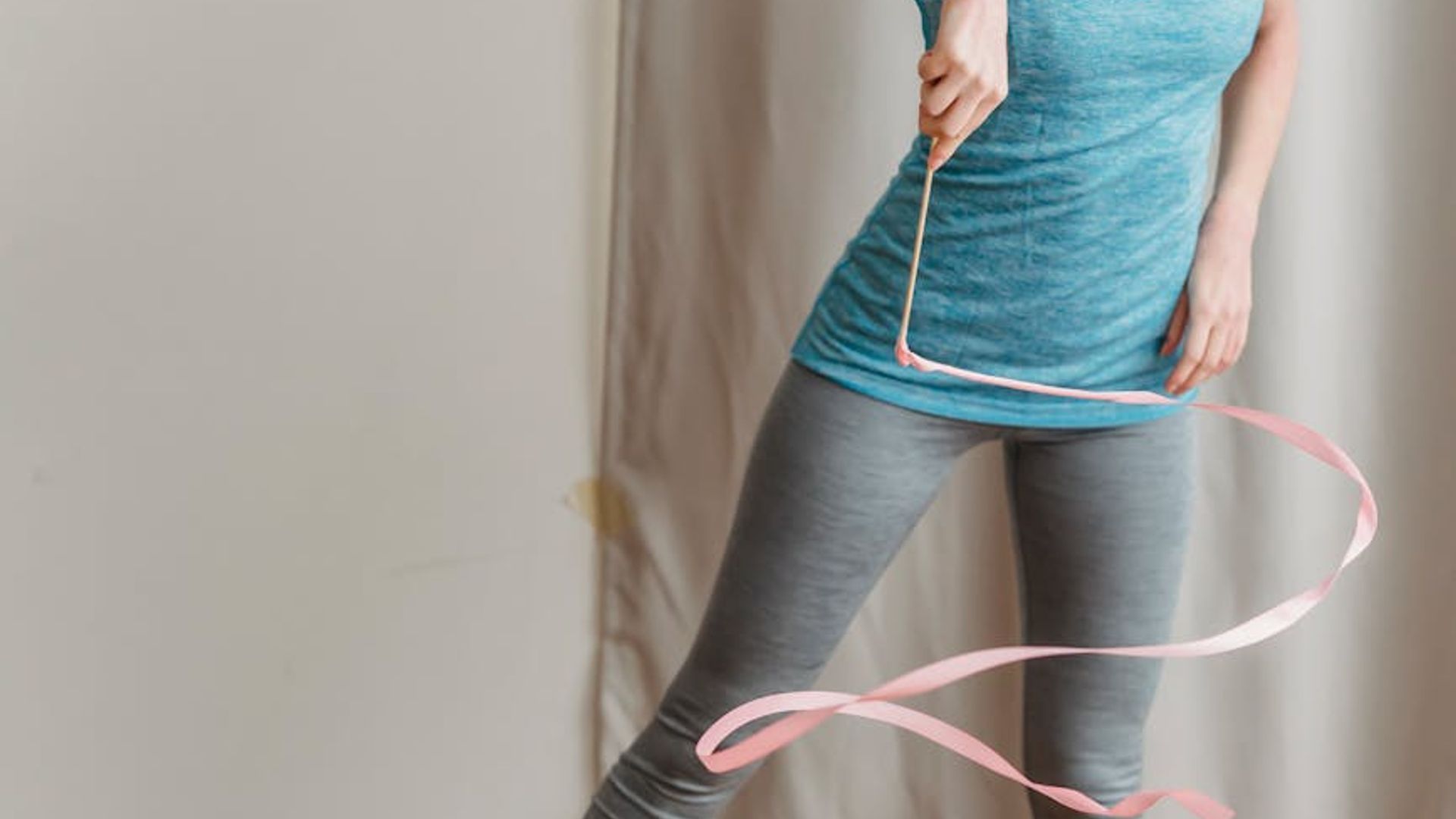 Active person doing light rhythmic exercises in a modern studio