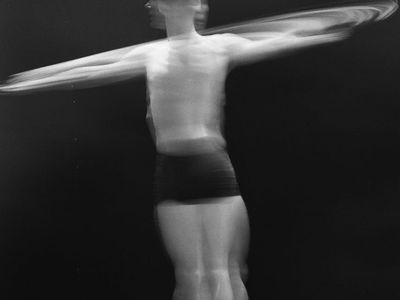 Silhouette of a person performing a fluid rhythmic motion